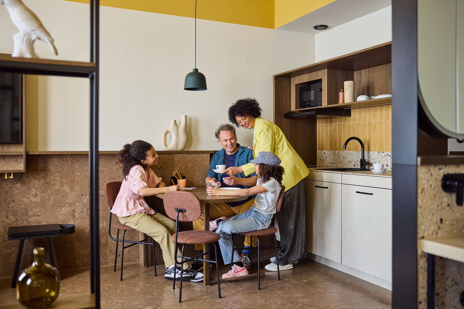 family in lounge area of The Studio room 